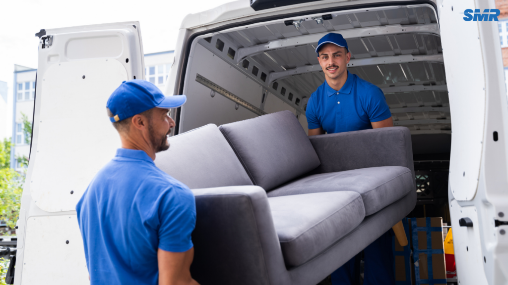 Mover carrying sofa for delivery in Battersea