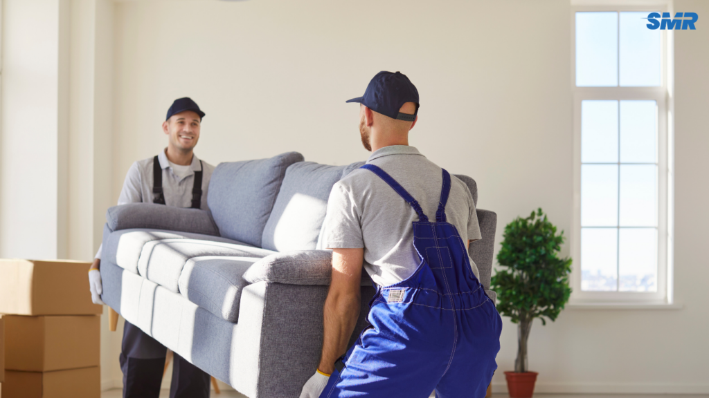Mover carrying sofa for delivery service in Bethnal Green
