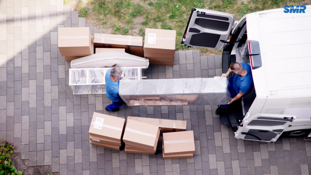 Two movers carrying sofa for 2 man and van Angel service