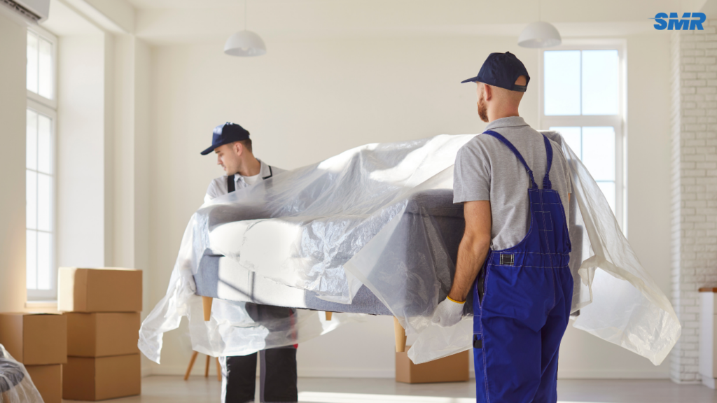 Mover carrying sofa for delivery service in Fulham