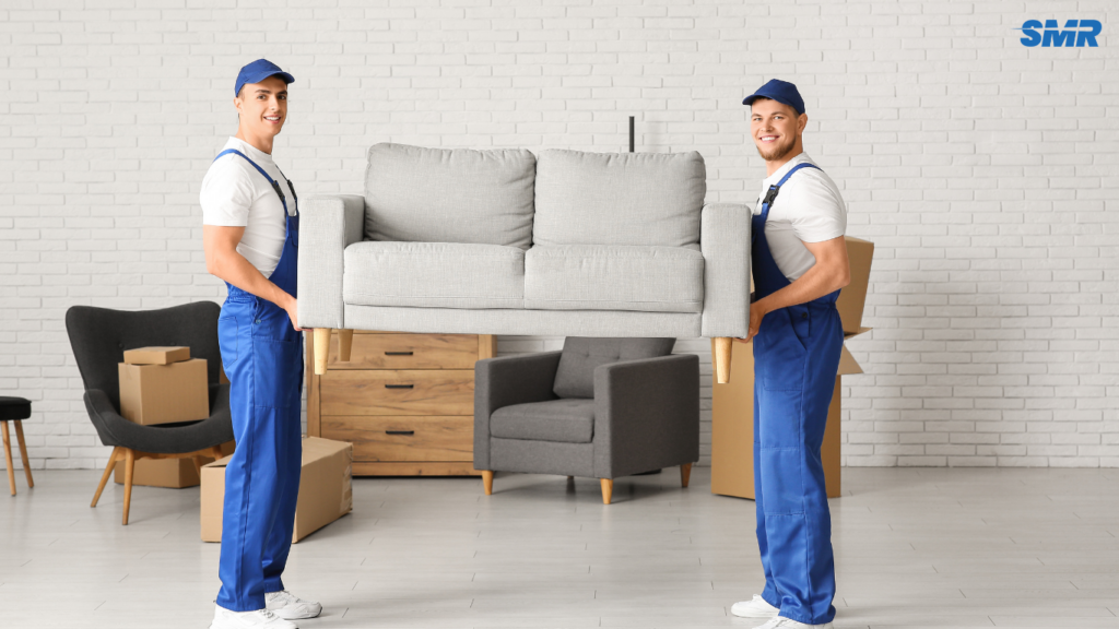Mover carrying sofa for delivery service in Brixton