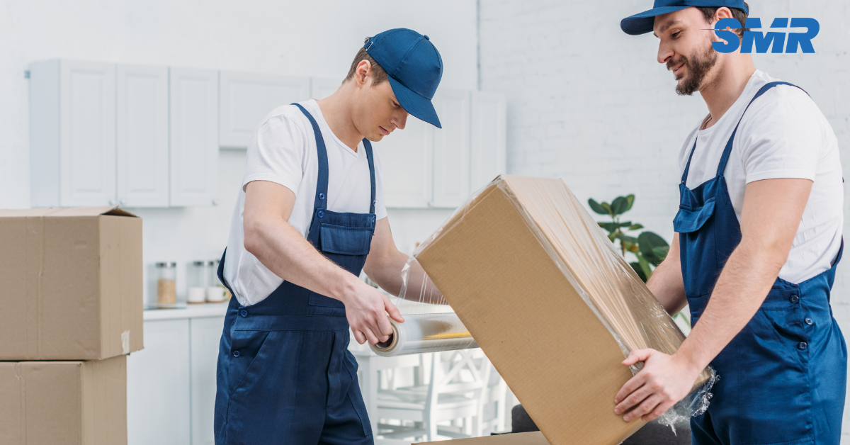house removals EN2 London with movers helping a family load furniture and boxes