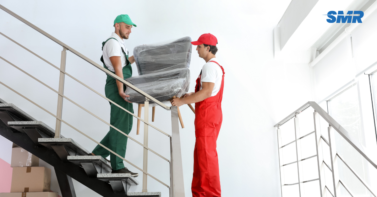 Movers handling protected furniture and packed boxes during a Dalston flat move