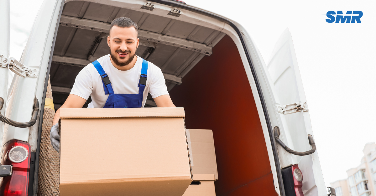Movers handling wrapped furniture and packed boxes during a Denmark Hill house move