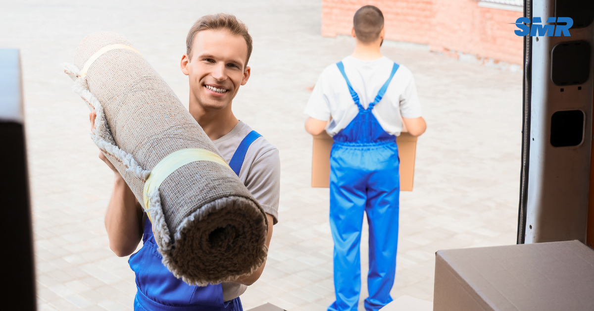Movers handling wrapped furniture and packed boxes during a Forest Gate house move