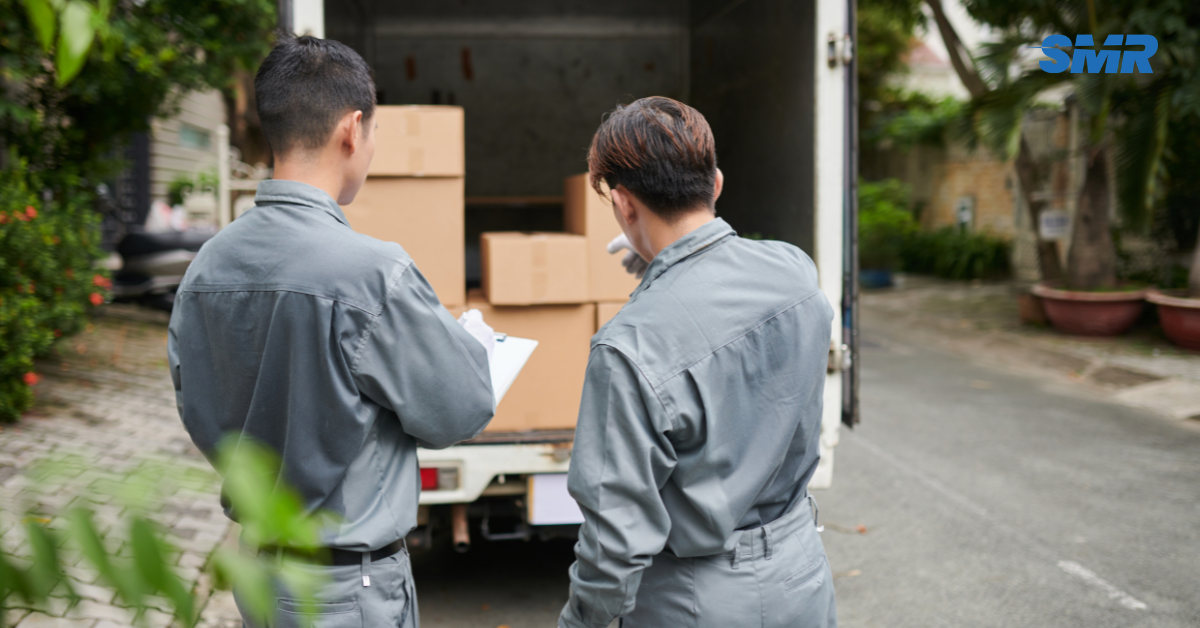 Movers handling wrapped furniture and packed boxes during an Enfield house move