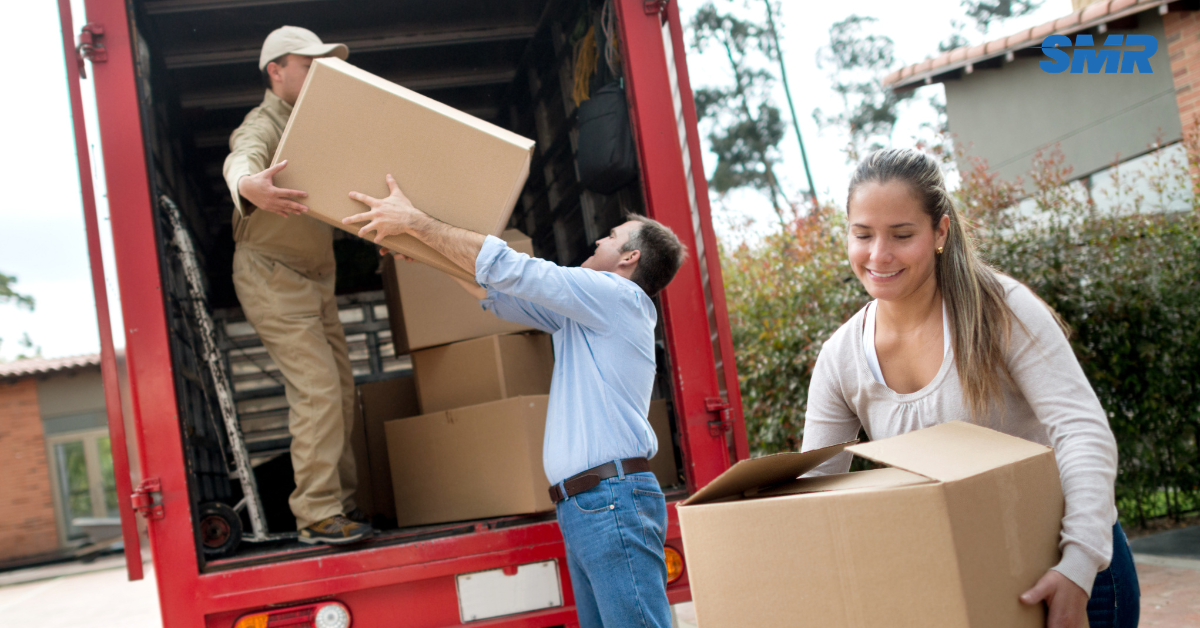 Movers handling protected furniture and packed boxes during a Chelsea house move