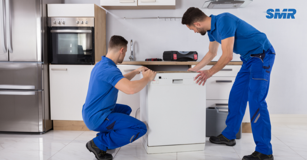 Movers carrying office desks and equipment