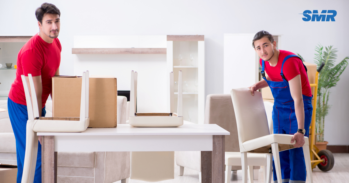 Professional Man and Van RM3 London movers loading furniture and boxes outside a home