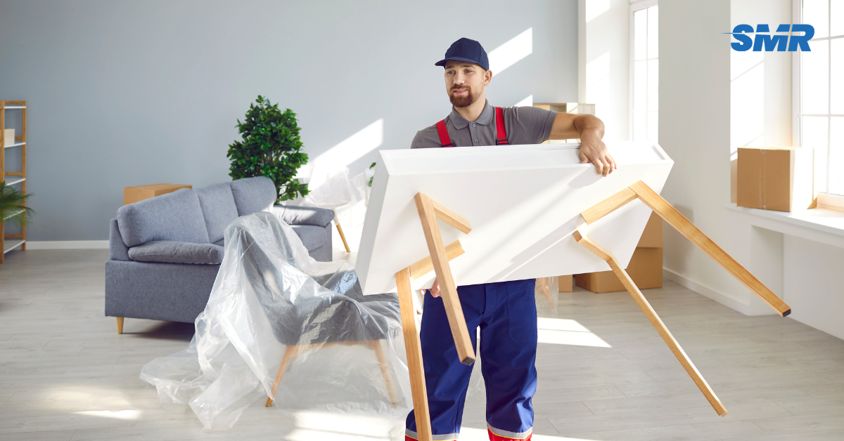 Professional man and van Hayes movers loading furniture into a removal van