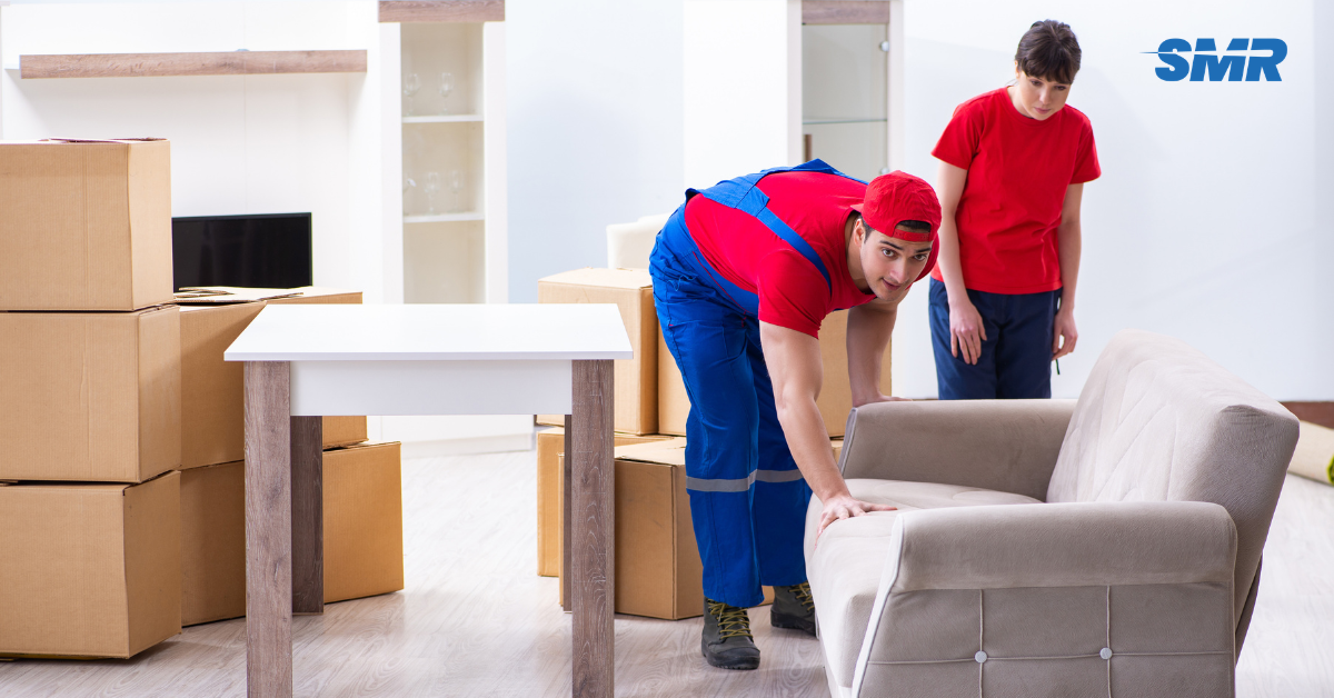 Professional Man and Van RM5 London movers loading furniture and boxes outside a home