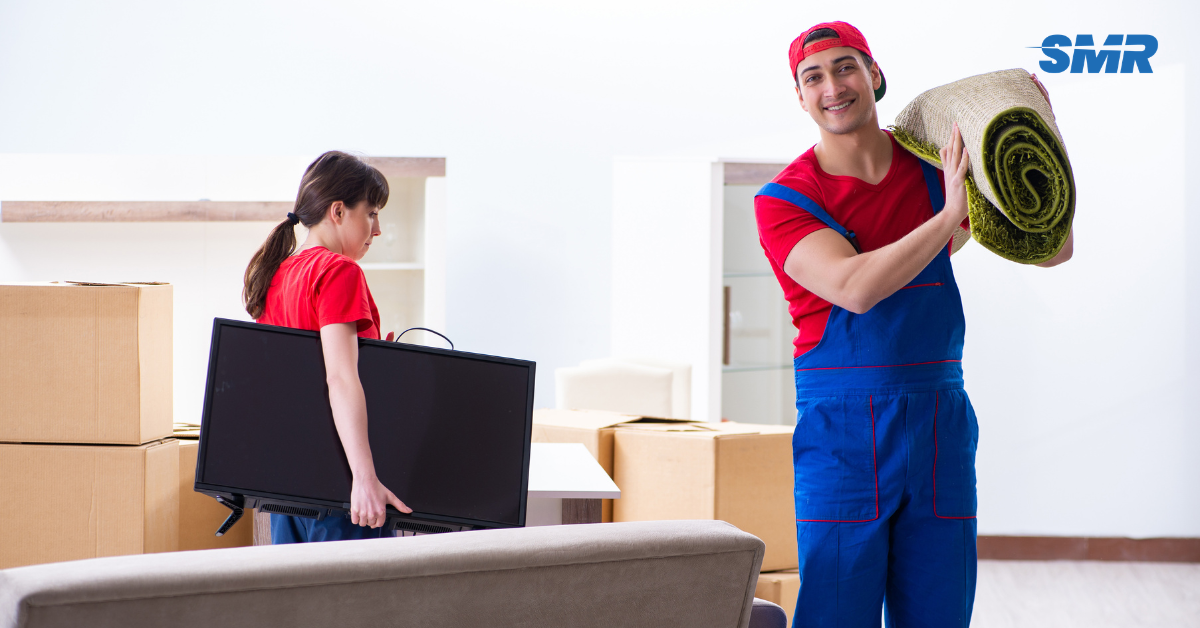 Professional Man and Van RM14 London movers loading boxes outside a home