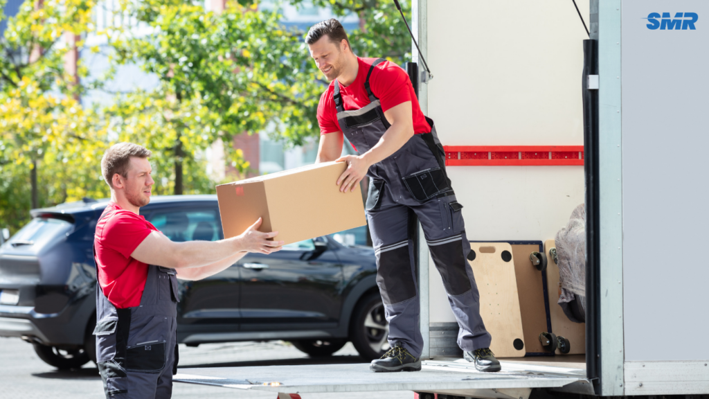 Movers carrying office equipment