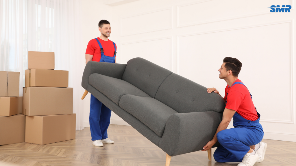 Movers transporting sofa and flat-pack furniture