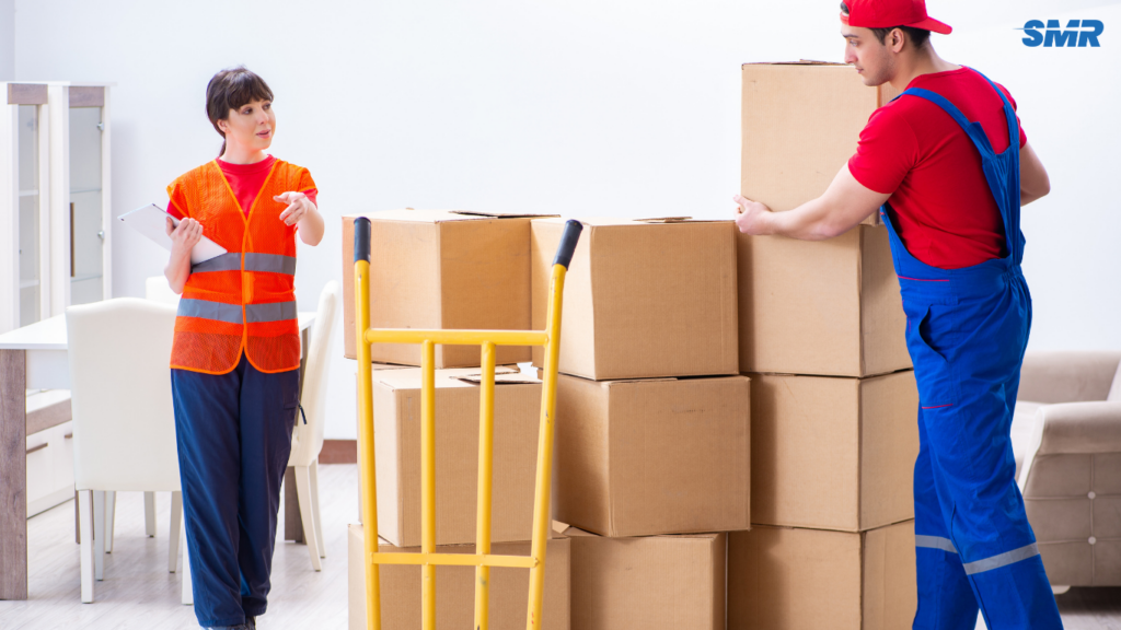 Movers carrying office equipment