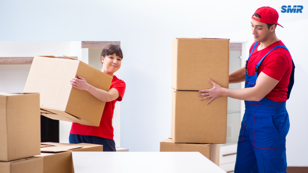 Movers carrying office equipment