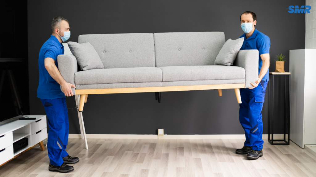 Movers transporting sofa and flat-pack furniture