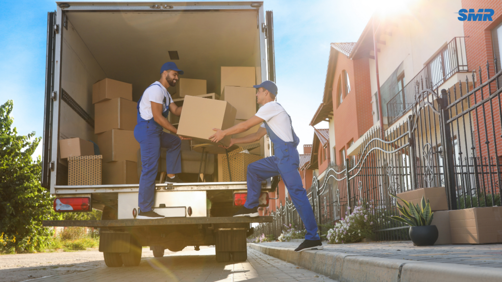 Movers carrying office furniture and equipment
