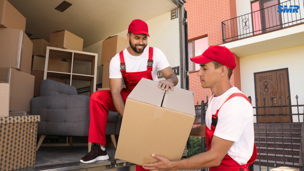 Movers transporting package boxes and flat-pack furniture
