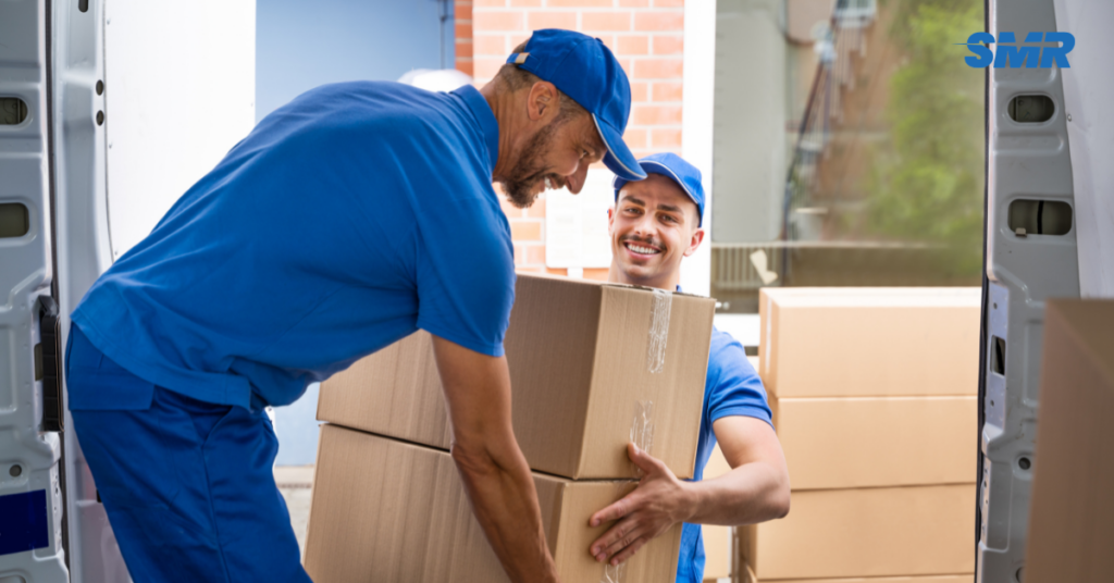 Sureman Removals man and van SW14 London team loading boxes outside a home in Mortlake or East Sheen