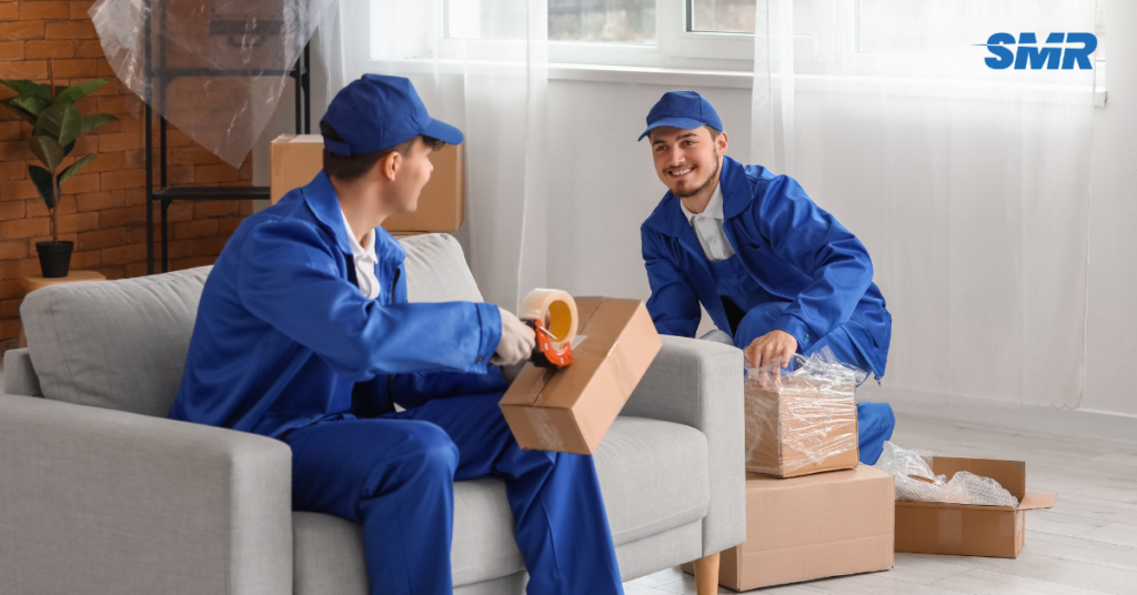 Flat removals Bayswater man and van movers carrying wrapped boxes from an apartment