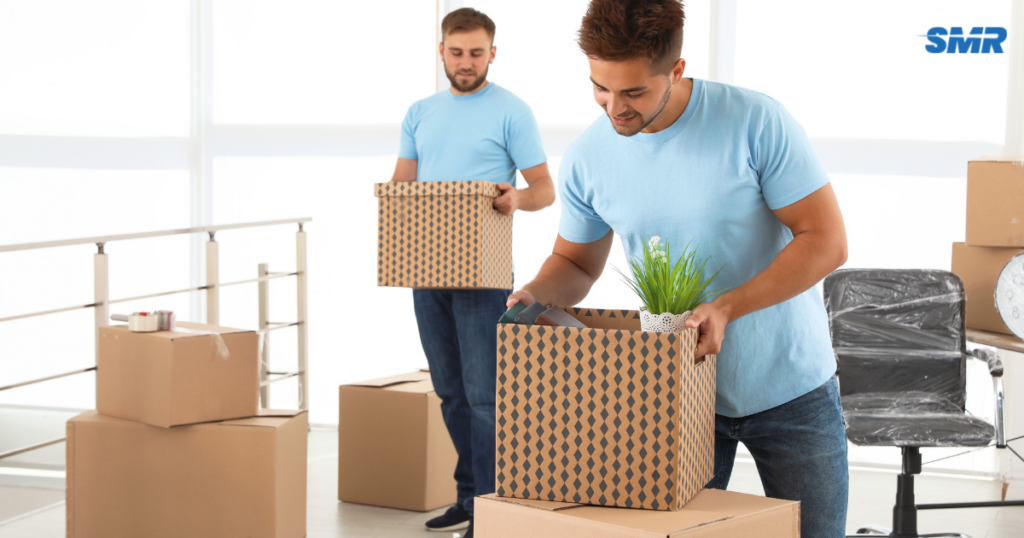 Man and Van Grays RM17 movers loading furniture and moving boxes into a removals van