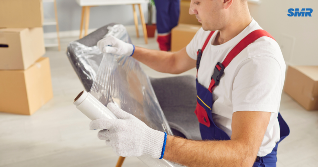 Affordable Man and Van Hammersmith movers carrying furniture into a house