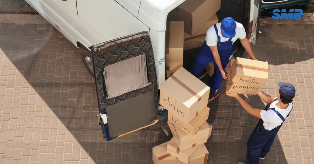 Movers carrying boxes in SW9 apartment